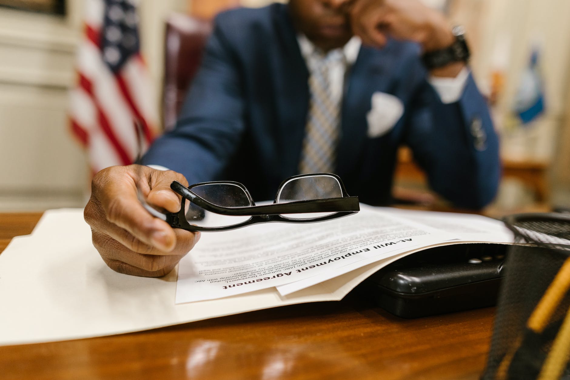 man in black framed eyeglasses and blue suit jacket